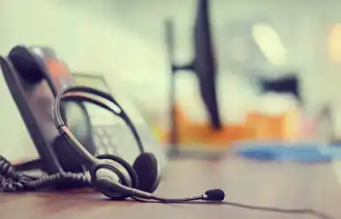 A pair of headphones sitting on top of a wooden table.